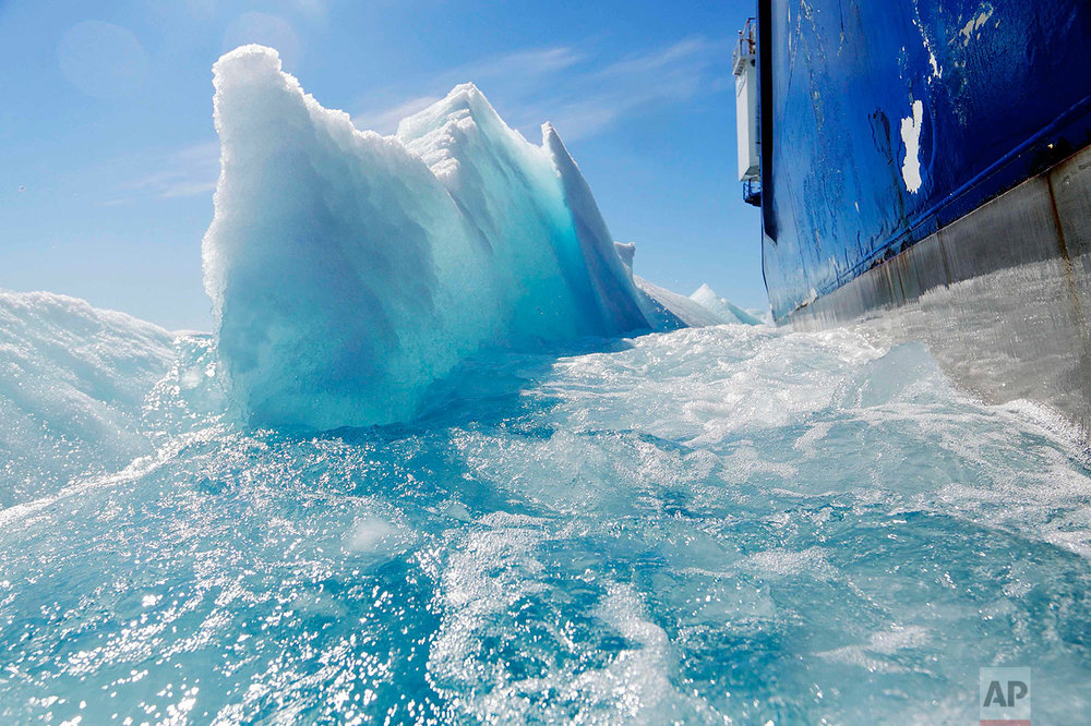  Broken sea ice emerges from under the hull of the Finnish icebreaker MSV Nordica as it sails through the Victoria Strait while traversing the Arctic's Northwest Passage, Friday, July 21, 2017. (AP Photo/David Goldman) 