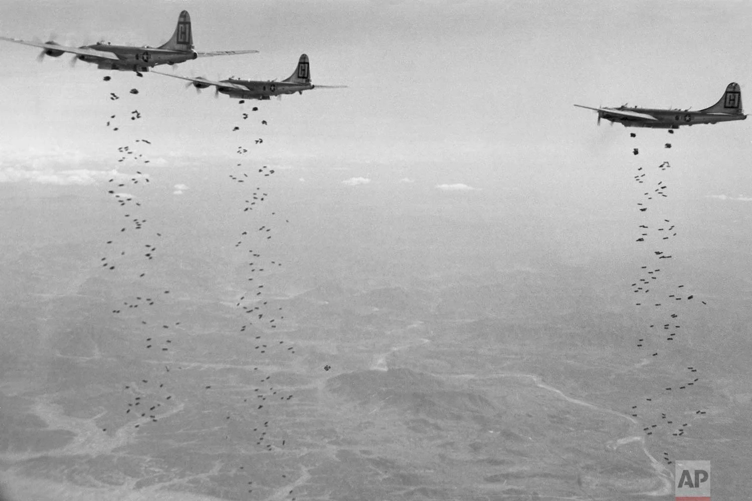 In this Jan. 18, 1951, file photo, Bomber Command planes of the U.S. Far East Air Forces rain tons of high demolition bombs in North Korea. (U.S. Air Force via AP)