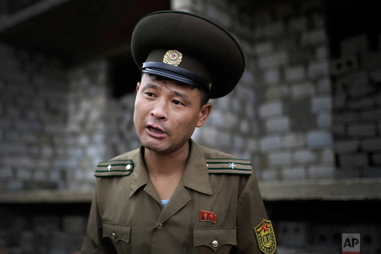 In this Friday, July 21, 2017, photo, Maj. Jong Il Hyon, 44, a member of a bomb squad for South Hamgyong, speaks to The Associated Press at a construction site on the outskirts of Hamhung, North Korea's second-largest city, where workers unearthed a rusted but still potentially deadly mortar round in February. (AP Photo/Wong Maye-E)