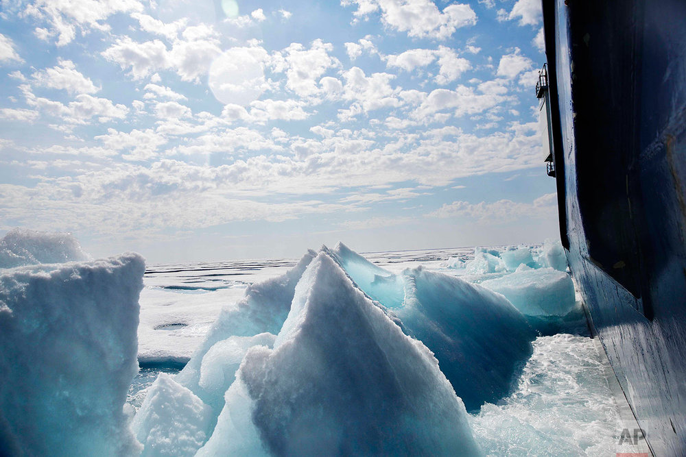  Broken sea ice emerges from under the hull of the Finnish icebreaker MSV Nordica as it sails through the Franklin Strait while traversing the Arctic's Northwest Passage, Saturday, July 22, 2017. Sea ice forms when the top layer of water reaches free