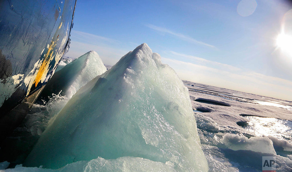  Broken sea ice emerges from under the hull of the Finnish icebreaker MSV Nordica as it sails through the Victoria Strait while traversing the Arctic's Northwest Passage, Friday, July 21, 2017. Sea ice forms when the top layer of water reaches freezi