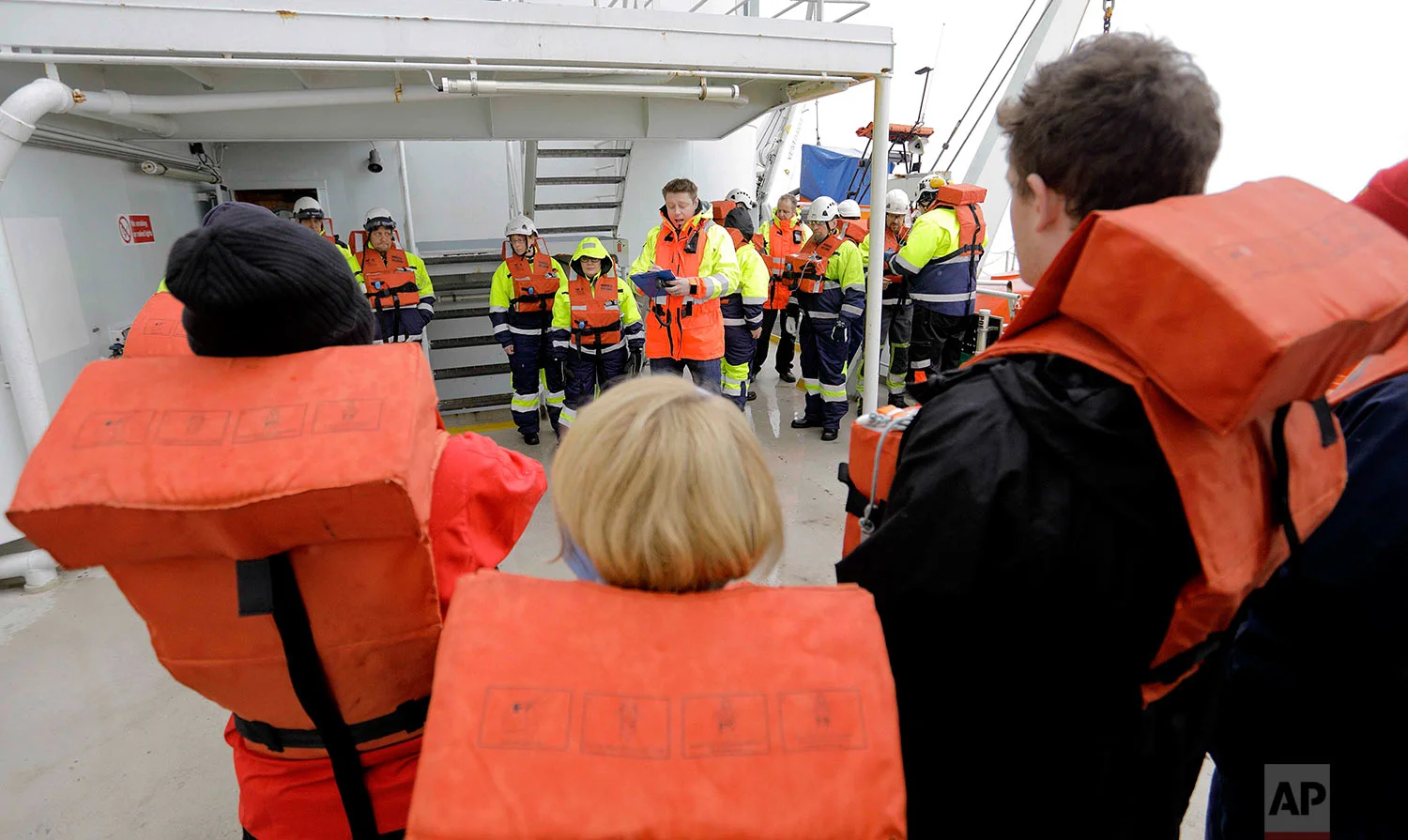 Second officer Ilkka Alhoke, center, conducts a safety drill aboard the Finnish icebreaker MSV Nordica as it sails through Barrow Strait while traversing the Northwest Passage through the Canadian Arctic Archipelago, Sunday, July 23, 2017. (AP Photo/David Goldman) 