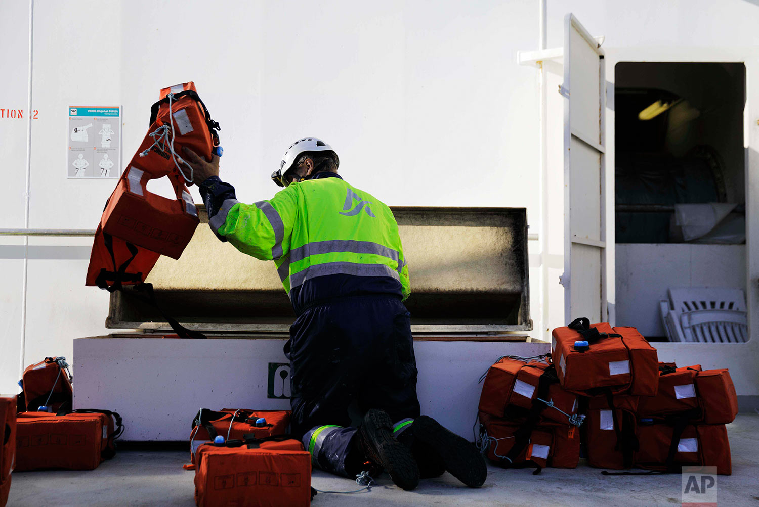 Able seaman Auvo Sinkkonen puts away life vests after a safety drill aboard the Finnish icebreaker MSV Nordica as it sails the Northwest Passage through the Canadian Arctic Archipelago, Thursday, July 6, 2017. (AP Photo/David Goldman) 