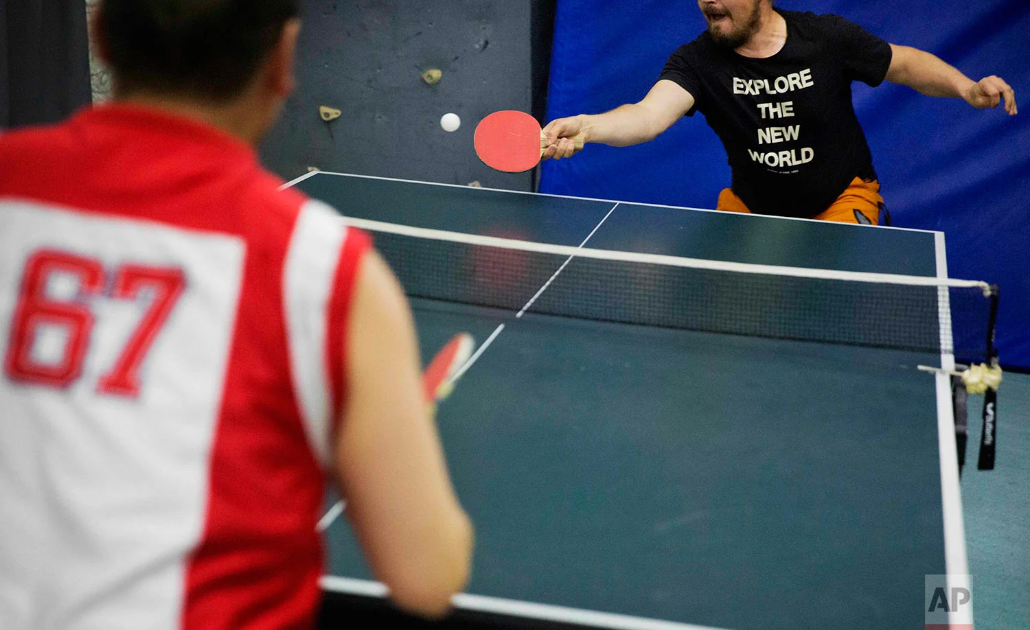 In this Saturday, July 8, 2017 photo, researcher Ari Laakso, right, plays ping pong with trainee Maatiusi Manning aboard the Finnish icebreaker MSV Nordica as it sails the North Pacific Ocean to traverse the Northwest Passage through the Canadian Arctic Archipelago. (AP Photo/David Goldman)