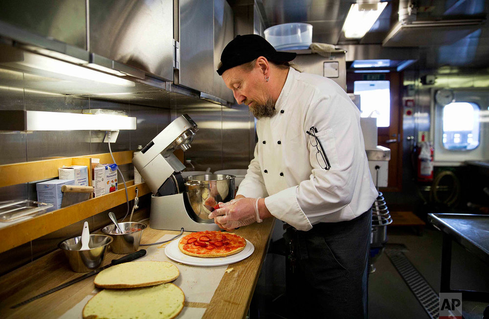  In this Saturday, July 8, 2017 photo, chief steward Mika Tiilikka prepares a strawberry cake aboard the Finnish icebreaker MSV Nordica as it sails the North Pacific Ocean to traverse the Northwest Passage through the Canadian Arctic Archipelago. (AP