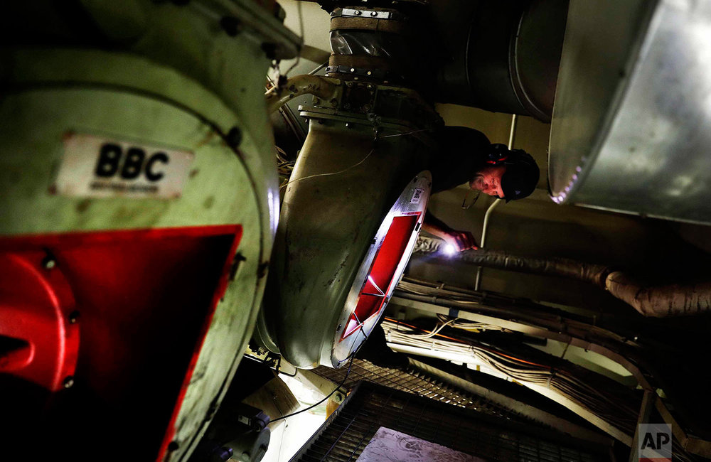  In this Sunday, July 9, 2017 photo, first engineer Kristian Autio does a check of the engine room aboard the Finnish icebreaker MSV Nordica as it sails the North Pacific Ocean to traverse the Northwest Passage through the Canadian Arctic Archipelago