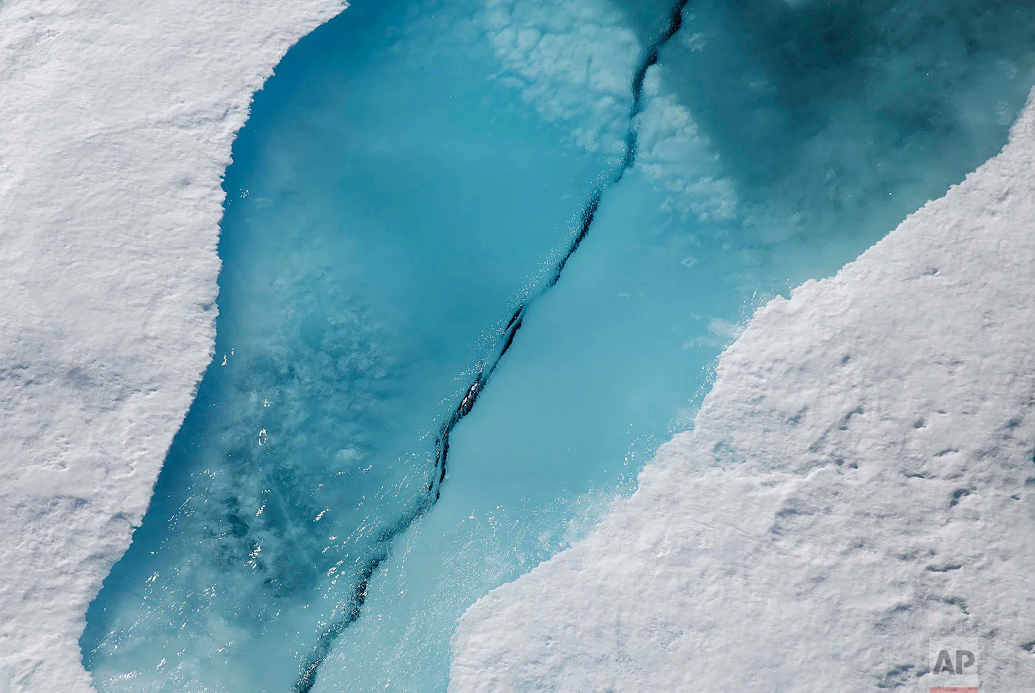 Sea ice cracks as the Finnish icebreaker MSV Nordica passes through the Victoria Strait along the Northwest Passage in the Canadian Arctic Archipelago, Friday, July 21, 2017. Sea ice helps maintain ocean and atmospheric currents that affect weather which is characteristic for certain parts of the world, such as the comparatively mild temperatures found in western Europe. (AP Photo/David Goldman)