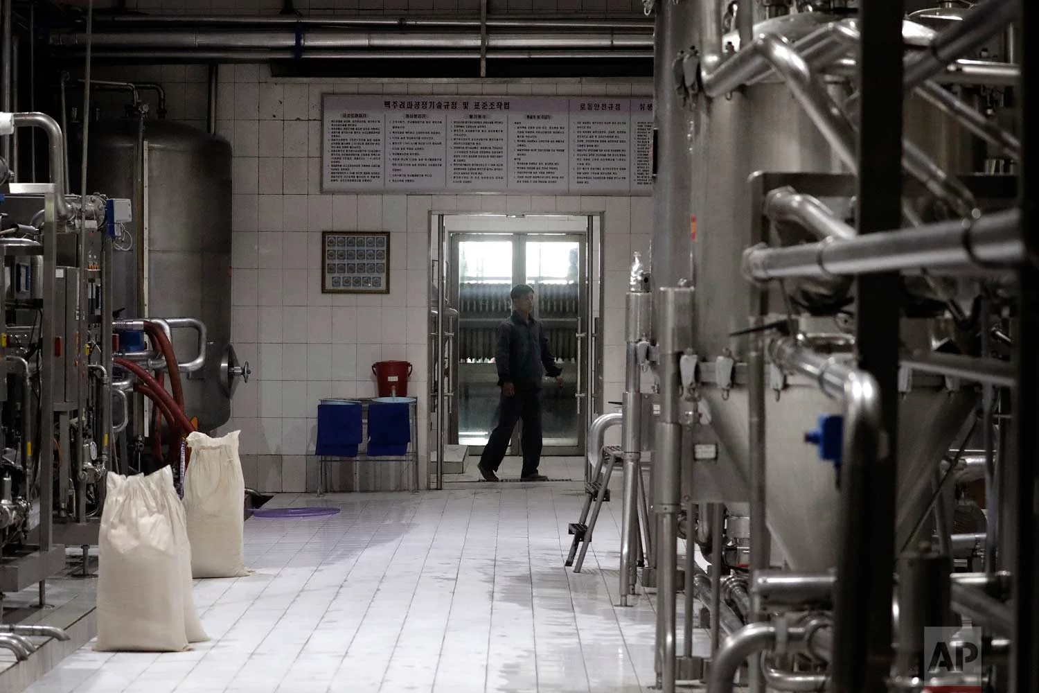 In this Wednesday, July 26, 2017, photo, a worker monitors machinery used to brew beer at the Taedonggang Brewery in Pyongyang, North Korea. (AP Photo/Wong Maye-E)