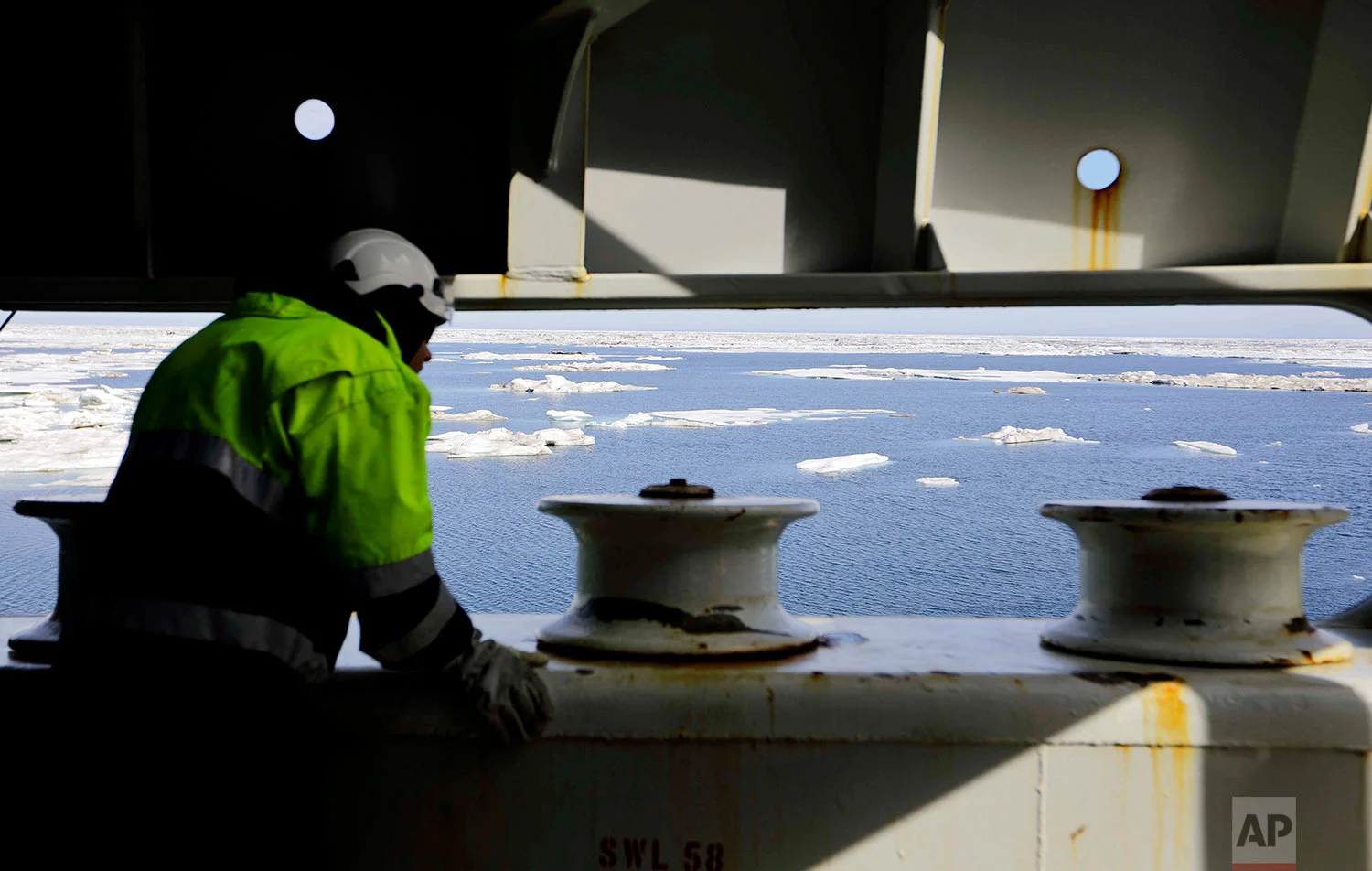 Chief engineer Jukka-Pekka Silander watches from the bow of the the Finnish icebreaker MSV Nordica as it sails into floating sea ice on the Beaufort Sea off the coast of Alaska while traversing the Arctic's Northwest Passage, Sunday, July 16, 2017. Sea ice plays an important role in the global climate system by cooling the surrounding water and air. It helps maintain ocean and atmospheric currents that affect weather which is characteristic for certain parts of the world, such as the comparatively mild temperatures found in western Europe. (AP Photo/David Goldman) 