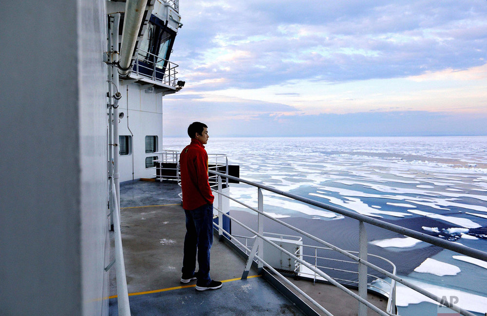 Trainee David Kullualik looks over the sea ice of Peel Sound. (AP Photo/David Goldman)