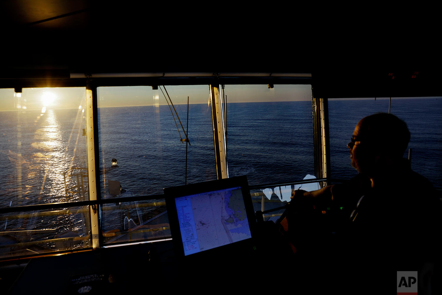 The sun lingers above the Bering Sea at midnight as second officer Juha Tuomi overseas the navigation of the Finnish icebreaker MSV Nordica as it sails toward the Canadian Arctic Archipelago to traverse the Northwest Passage, early Thursday, July 13