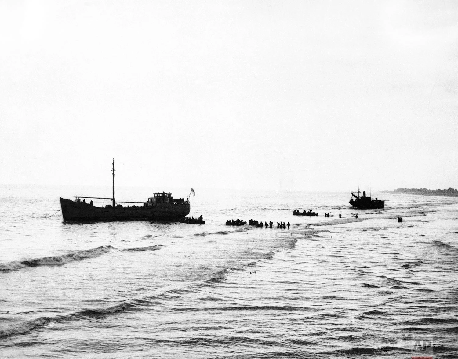 Soldiers of the British Expeditionary Force wade out to some of the little ships that are attempting to evacuate them from Dunkirk, France, on June 1, 1940. (AP Photo)