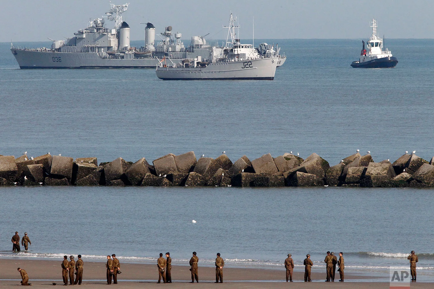 Actors wait on the beach before filming a scene for the film, "Dunkirk," in Dunkirk, northern France, Thursday, May 26, 2016. The film, directed by Christopher Nolan, tells the story of the Dunkirk evacuation. (AP Photo/Michel Spingler) 