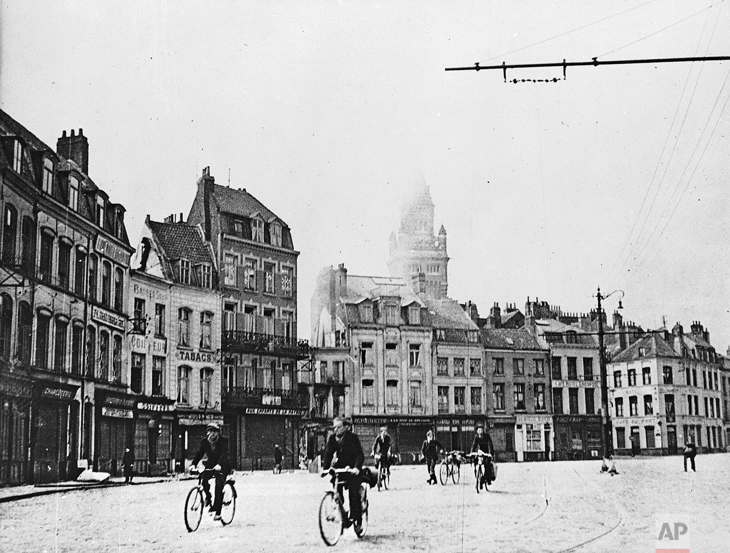  Houses in this Dunkirk, France, square had been deserted and most of the town had been destroyed in this photo, showing the last civilians in the town hurrying across the square en route to the waterfront to seek passage aboard boats bound for other