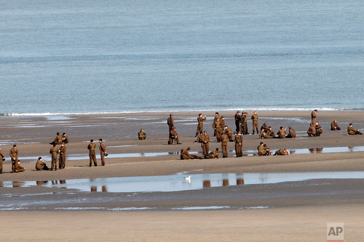  Actors wait on the beach before filming a scene for the film, "Dunkirk," in Dunkirk, northern France, Thursday, May 26, 2016. The film, directed by Christopher Nolan, tells the story of the Dunkirk evacuation, which took place at the beginning of Wo