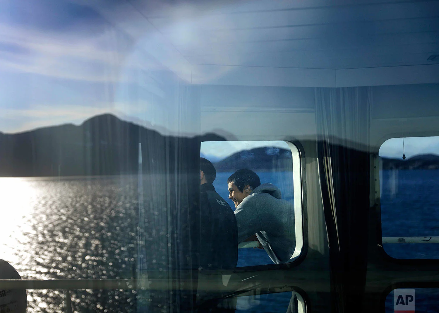 Trainee David Kullualik looks out as the Finnish icebreaker MSV Nordica arrives into Nuuk, Greenland, after traversing the Northwest Passage through the Canadian Arctic Archipelago, Saturday, July 29, 2017. After 24 days at sea and a journey spanning more than 10,000 kilometers (6,214 miles), the MSV Nordica has set a new record for the earliest transit of the fabled Northwest Passage. The once-forbidding route through the Arctic, linking the Pacific and the Atlantic oceans, has been opening up sooner and for a longer period each summer due to climate change. (AP Photo/David Goldman)