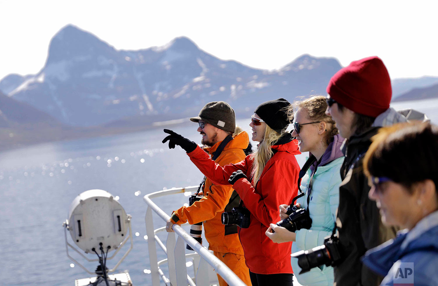 Tiina Jaaskelainen, second from left, and fellow researchers look out from the Finnish icebreaker MSV Nordica as it arrives into Nuuk, Greenland, after traversing the Northwest Passage through the Canadian Arctic Archipelago, Saturday, July 29, 2017. After 24 days at sea and a journey spanning more than 10,000 kilometers (6,214 miles), the MSV Nordica has set a new record for the earliest transit of the fabled Northwest Passage. The once-forbidding route through the Arctic, linking the Pacific and the Atlantic oceans, has been opening up sooner and for a longer period each summer due to climate change. (AP Photo/David Goldman)