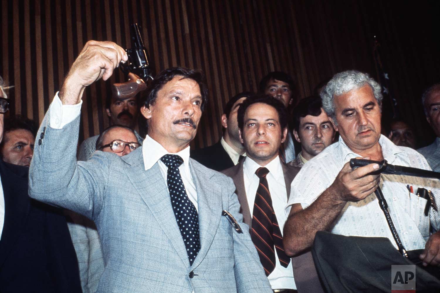 Police officer Edward Zigo holds up the .44-caliber revolver in Brooklyn, Thursday, Aug. 11, 1977. (AP Photo)