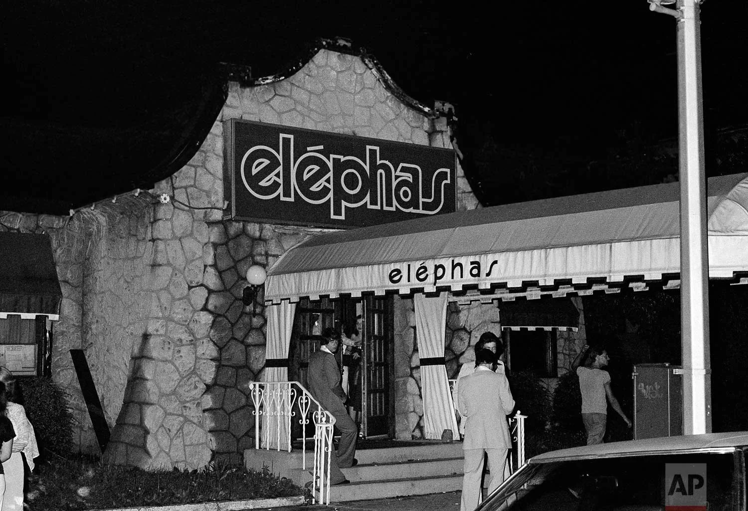 People stand outside of the Elephas nightclub in the early morning hours of June 26, 1977, in the Bayside section of the Queens borough of New York, where a young couple parked near the club were shot by the “.44 Caliber Killer” also known as the "Son of Sam". (AP Photo)