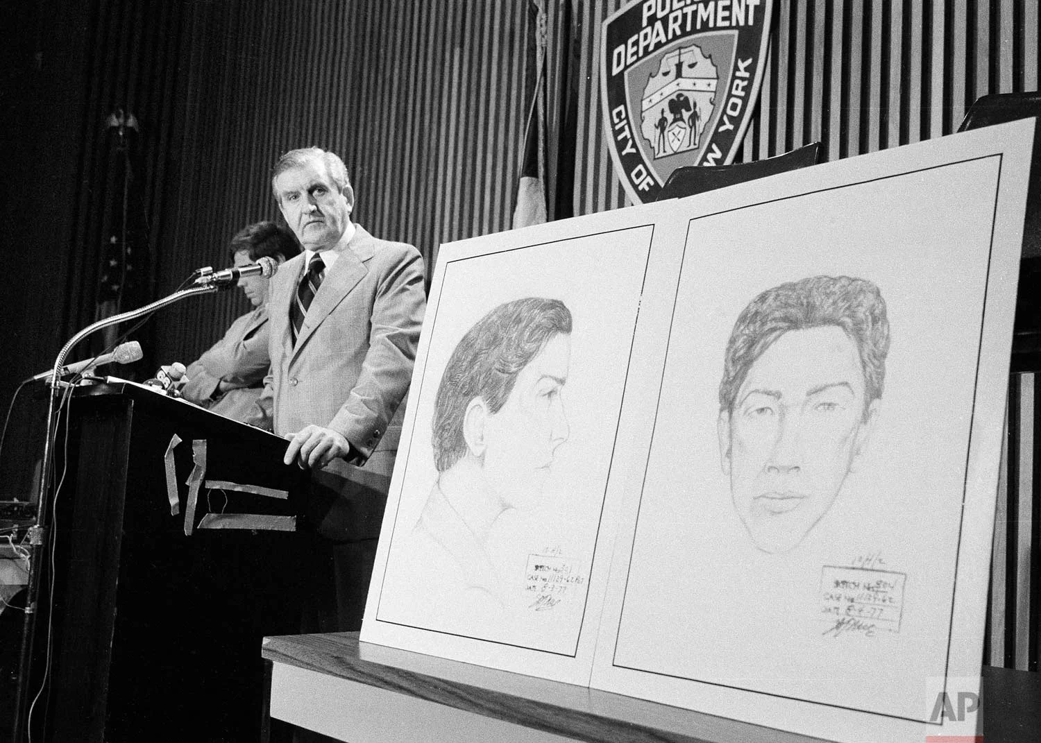 John Keenan, chief of detectives, speaks at a press conference at New York City Police headquarters after two new sketches of the “.44 Caliber Killer” were unveiled at right, Aug. 9, 1977. Police said the killer, also know as "Son of Sam", who has slain six persons and wounded seven during the past year, is 25 to 32 years old, white, 5 feet 8 to 5 feet 9 inches tall and weighs 165 to 175 pounds. (AP Photo/Ray Howard)