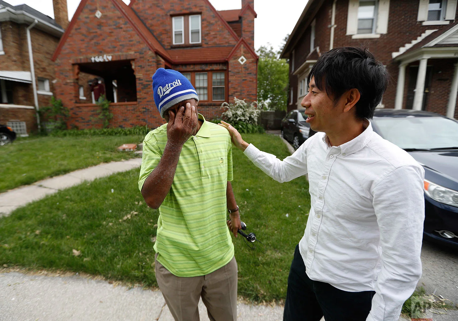 John Hall, left, is overcome saying goodbye to Motoki Taniguchi, Reentry Coordinator with the Michigan State Appellate Defender Office in Detroit, Friday, May 19, 2017. (AP Photo/Paul Sancya)