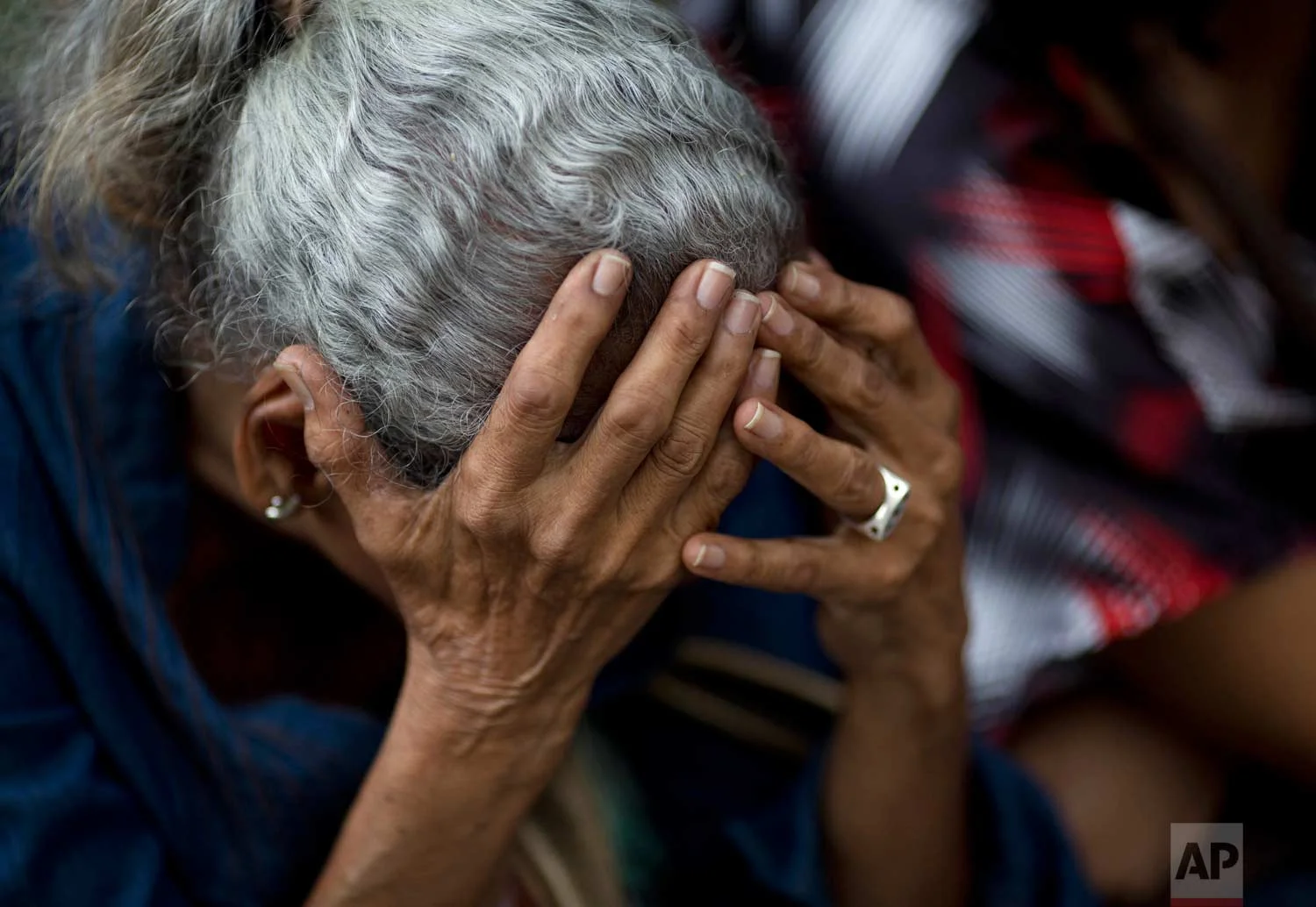 In this May 3, 2016 photo, an elderly woman waits in line outside a supermarket to buy food in Caracas, Venezuela. Nine out of 10 people said they can't buy enough to eat, according to a study by Simon Bolivar University. (AP Photo/Ariana Cubillos)