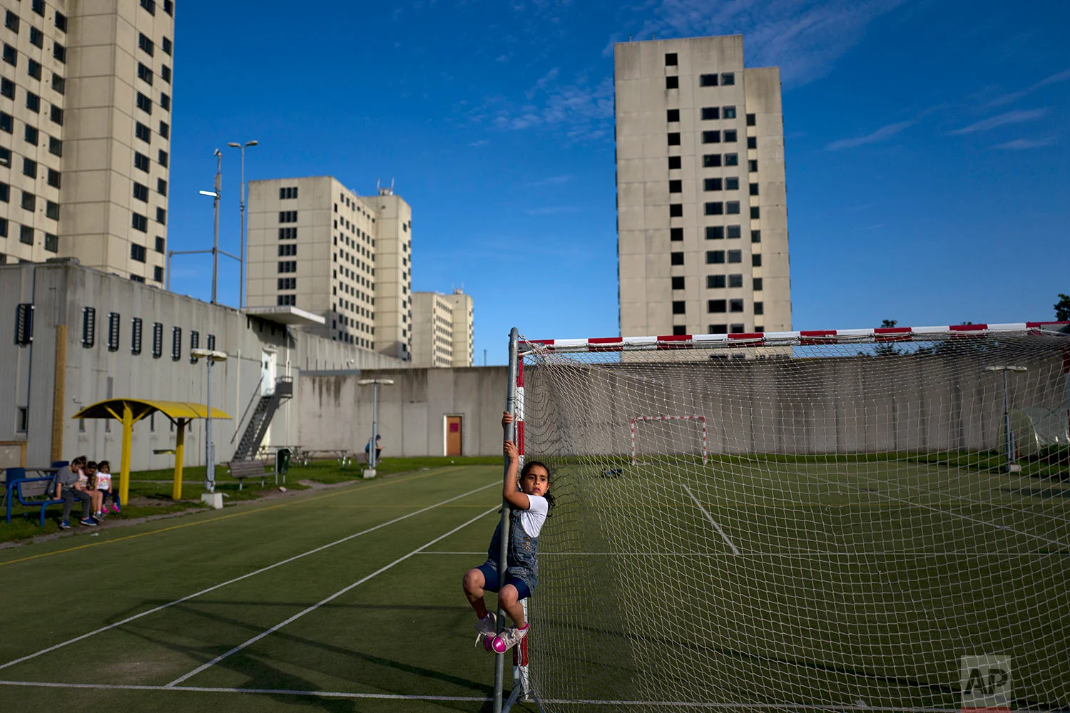 In this Tuesday, July 18, 2017 photo, refugee Amal Sakkal, 8, from Damascus, Syria, plays at the former prison of Bijlmerbajes in Amsterdam, Netherlands. (AP Photo/Muhammed Muheisen)