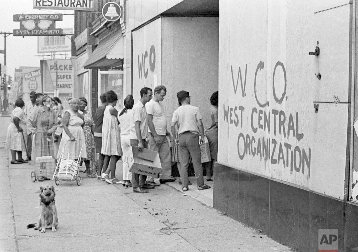 In this July 27, 1967 photo, residents of Detroit's riot area stand in line for free emergency food from a neighborhood organization. Hundreds of grocery stores were burned or looted during the rioting. (AP Photo)
