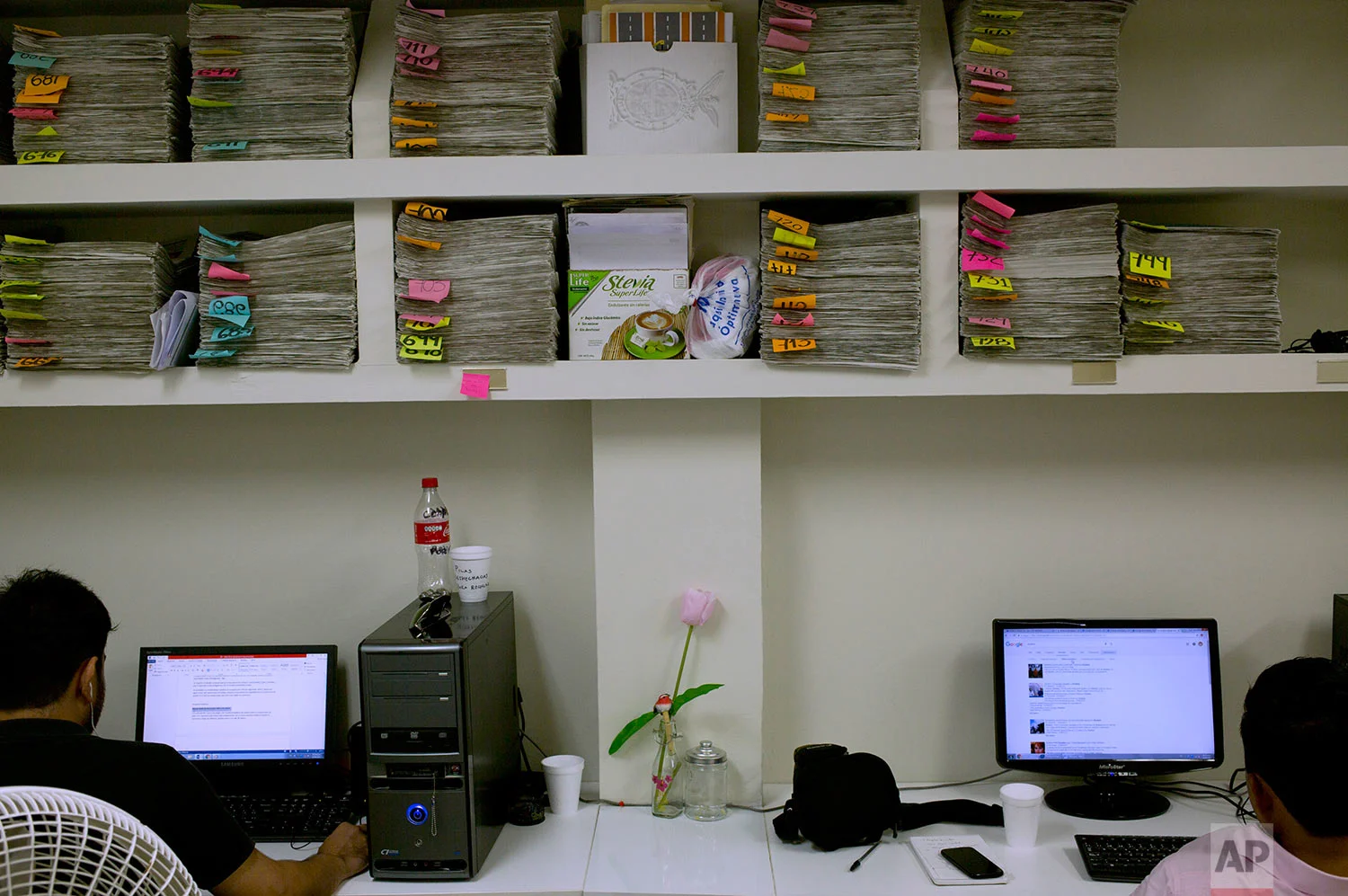 In this June 26, 2017 photo, reporters at Riodoce, a weekly magazine created in 2003 that has earned a reputation for brave and honest coverage, work on their computers in Culiacan, Sinaloa state, Mexico. Riodoce's offices are housed in a apartment building in Culiacan. (AP Photo/Enric Marti)