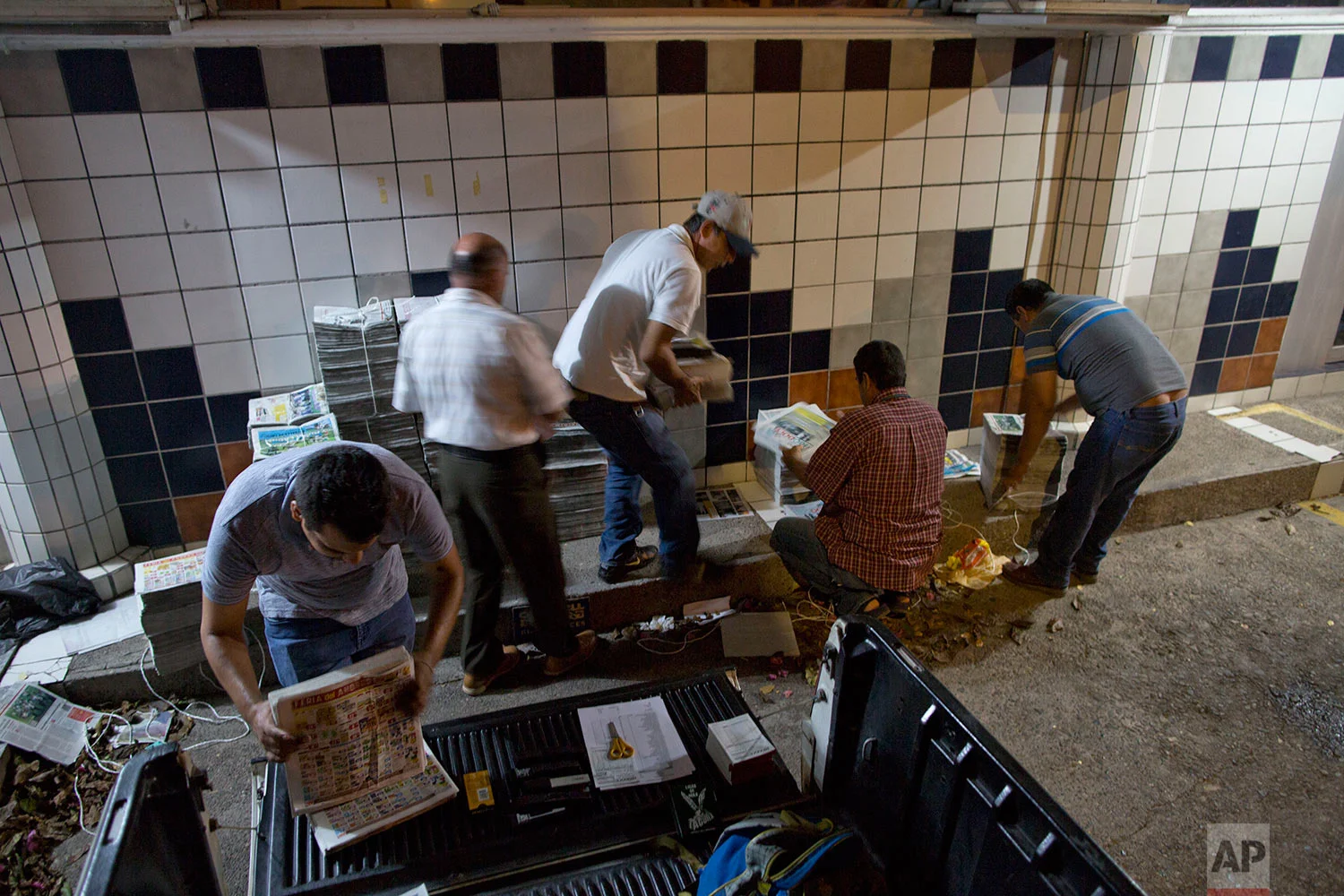 In this July 3, 2017 photo, drivers prepare to distribute Riodoce newspapers in Culiacan, Sinaloa state, Mexico. Riodoce, a weekly publication, was created in 2003 by five local journalists. Over time the paper earned a reputation for brave and honest coverage. (AP Photo/Enric Marti)
