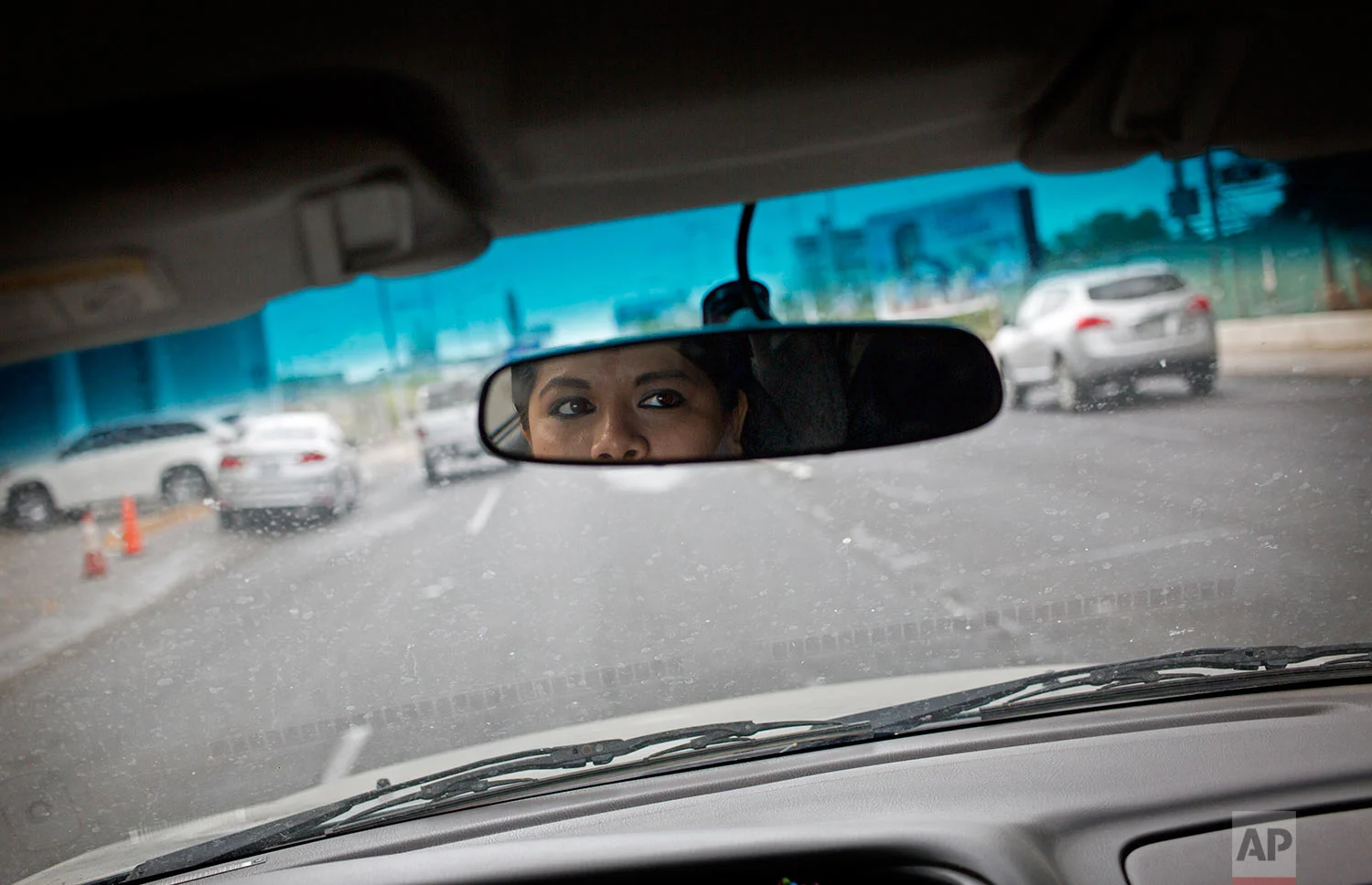 In this June 28, 2017 photo, Riodoce reporter Miriam Ramirez drives to her office in Culiacan, Sinaloa state, Mexico. After the killing of Riodoce co-founder Javier Valdez on May 15 and with an increase in killings of journalists nationwide, the newspaper's reporters are told by security experts that, among other things, it's important to change their routines, be more careful with social media and not leave colleagues alone in the office at night. (AP Photo/Enric Marti)