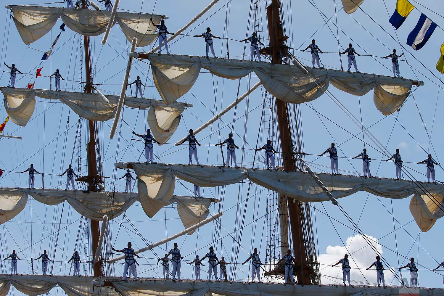  Mexican Navy crew members stand on the sails of the ARM Cuauhtemoc tall ship as it prepares to dock in the South Harbor in Manila, Philippines, for a five-day goodwill visit starting Friday, Aug. 4, 2017. (AP Photo/Bullit Marquez) 