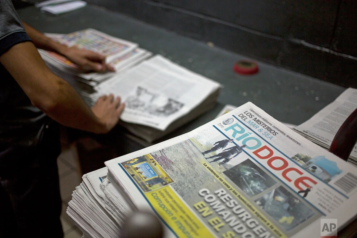 In this July 1, 2017 photo, workers fold an issue of the weekly Riodoce after it was printed in Culiacan, Sinaloa state, Mexico. Riodoce was created in 2003 by five local journalist including the late Javier Valdez selling $50 shares. In Sinaloa, "it was impossible to do journalism without touching the narco issue," said director and co-founder Ismael Bojorquez. Over time the paper earned a reputation for brave and honest coverage. (AP Photo/Enric Marti)