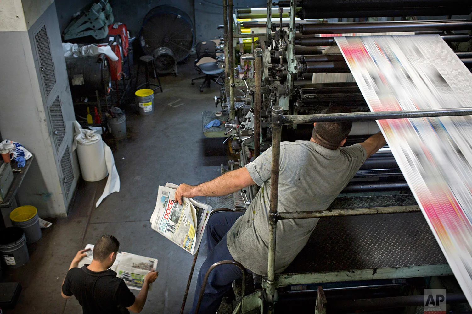 In this late, July 1, 2017 photo, workers print the latest issue of the weekly newspaper Riodoce, in Culiacan, Sinaloa state, Mexico. Journalists at Riodoce persist in covering the violence of Sinaloa, though they are heartbroken after the murder of their paper's co-founder Javier Valdez and the terrain is more treacherous now. (AP Photo/Enric Marti)
