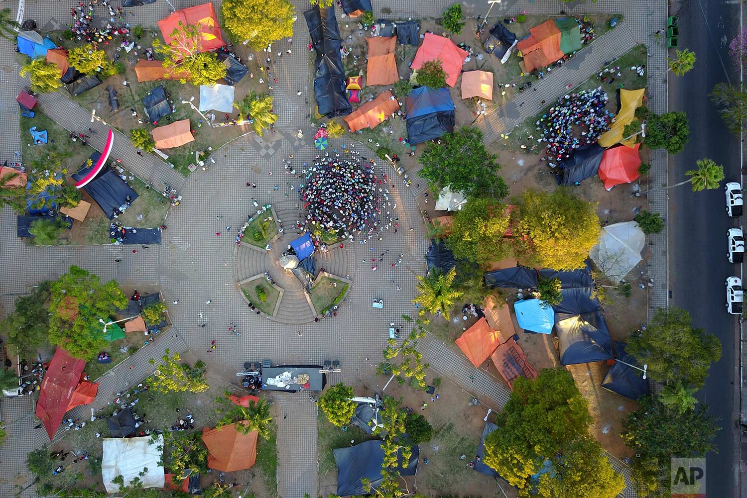 Farmers from northern Paraguay participate in a meeting at their camp at the "Plaza de Armas" in downtown Asuncion, Paraguay, Wednesday, July 12, 2017. (AP Photo/Jorge Saenz)