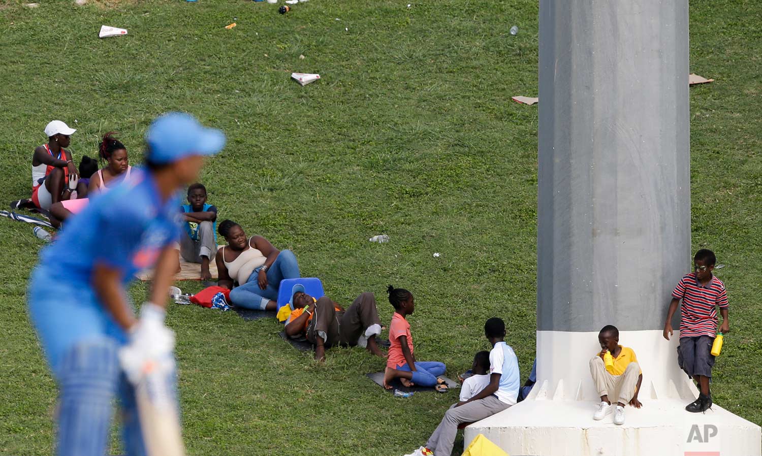 In this July 2, 2017 photo, spectators watch the fourth ODI cricket match between India and West Indies as India's MS Dhoni waits for a delivery at the Sir Vivian Richards Stadium in North Sound, Antigua and Barbuda. (AP Photo/Ricardo Mazalan)