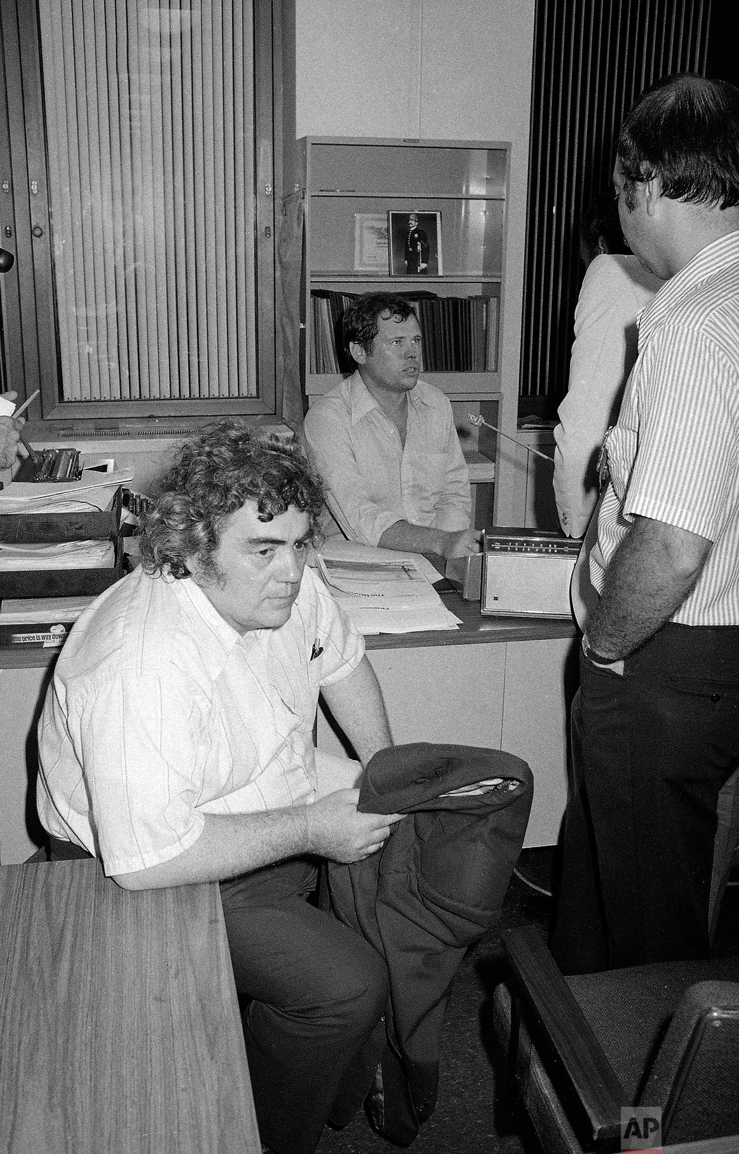 New York Daily News columnist Jimmy Breslin sits at police headquarters in New York after the arrest of David Berkowitz, the "Son of Sam" serial killer suspect, on Aug. 11, 1977. Berkowitz sent several cryptic messages to Breslin, who published them in the newspaper. (AP Photo)