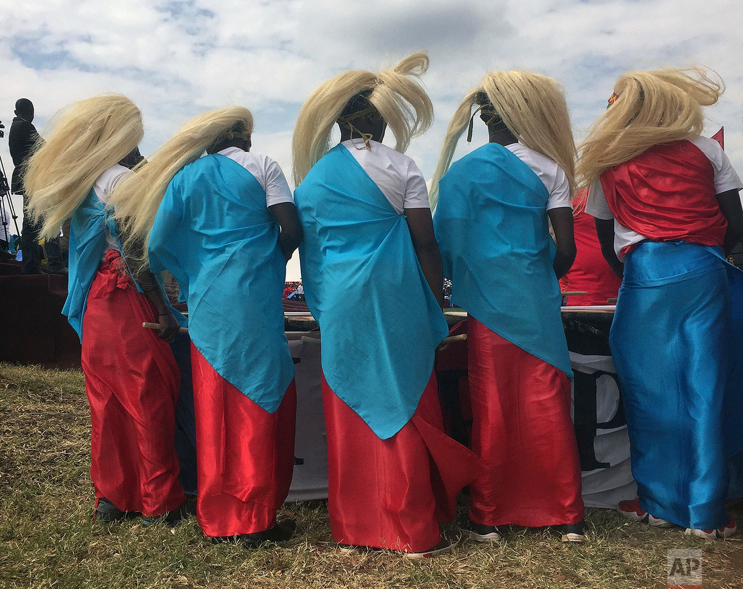 Traditional dancers wait for the arrival of Rwanda's President Paul Kagame at an election campaign rally on the hills overlooking Kigali, Rwanda, Wednesday Aug. 2, 2017. Kagame has been in power since the end of the country's genocide in 1994 and is widely expected to win another term in the Aug. 4 elections after the government earlier this month disqualified all but three candidates. (AP Photo/Jerome Delay)
