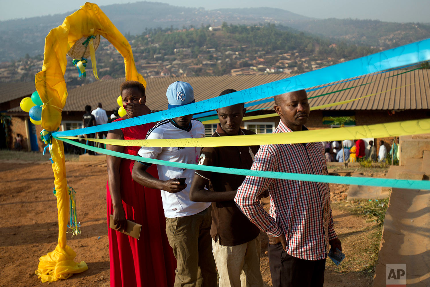 Voters line up to cast their vote at a polling station for the presidential election, Friday Aug. 4, 2017, in the capital Kigali, Rawanda. Incumbent President Paul Kagame is widely expected to win another term after the government disqualified three potential candidates for allegedly failing to fulfill certain requirements, including collecting enough signatures. (AP Photo/Jerome Delay)