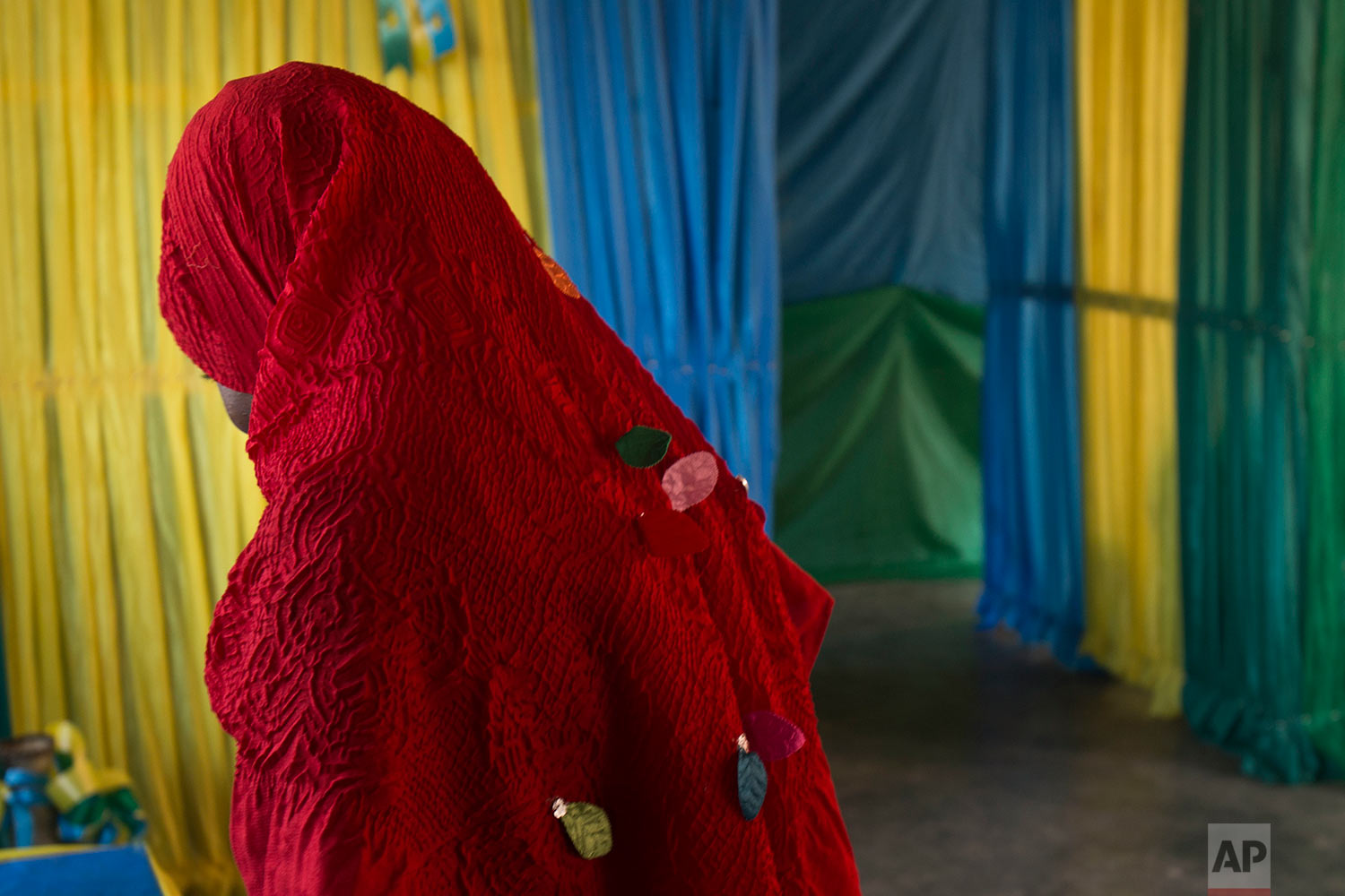 Rwandans start to vote in a polling station in Rwanda's capital Kigali Friday Aug. 4, 2017, in presidential elections. Rwandans voted in an election Friday that the country's longtime president is widely expected to win, after the government disqualified all but three candidates. (AP Photo/Jerome Delay)