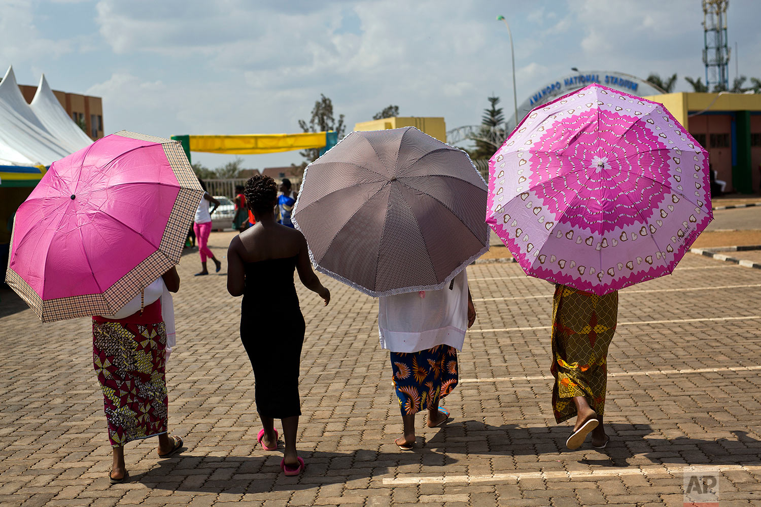 Women leave a polling station in Rwanda's capital Kigali Friday Aug. 4, 2017, after casting their votes in the presidential elections. Rwandans are voting in an election Friday that the country's longtime president is widely expected to win, after the government disqualified all but three candidates.(AP Photo/Jerome Delay)