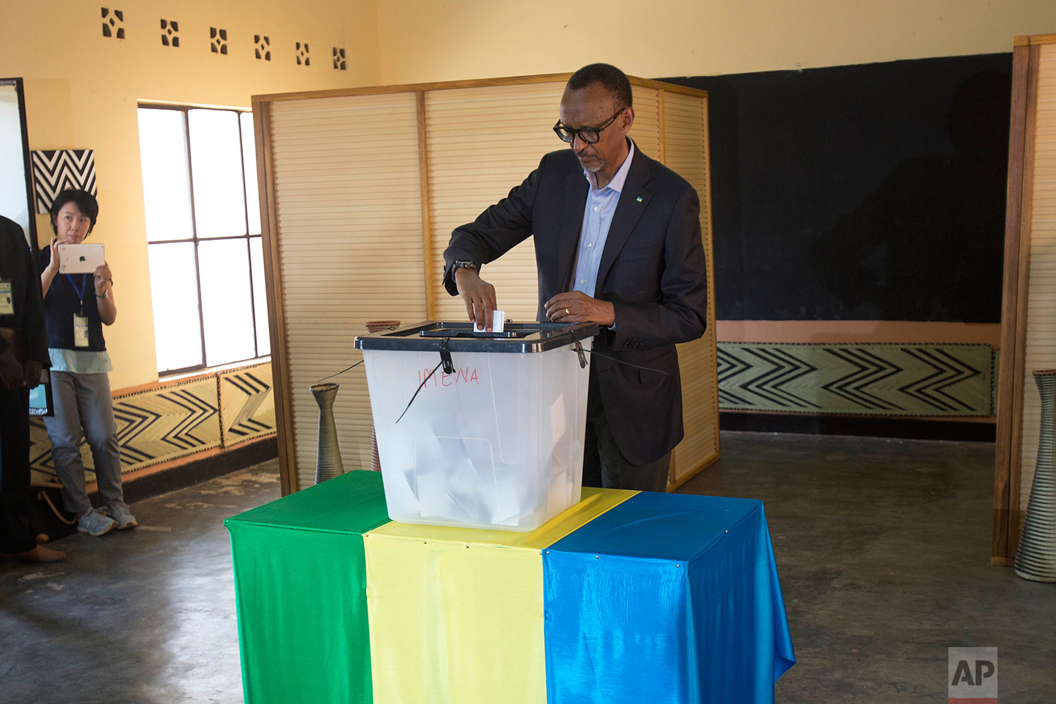  Rwandans President Paul Kagame casts his ballot in Rwanda's capital Kigali Friday Aug. 4, 2017 for the presidential elections in which he is widely expected to win another term after the government disqualified all but three candidates. (AP Photo/Je