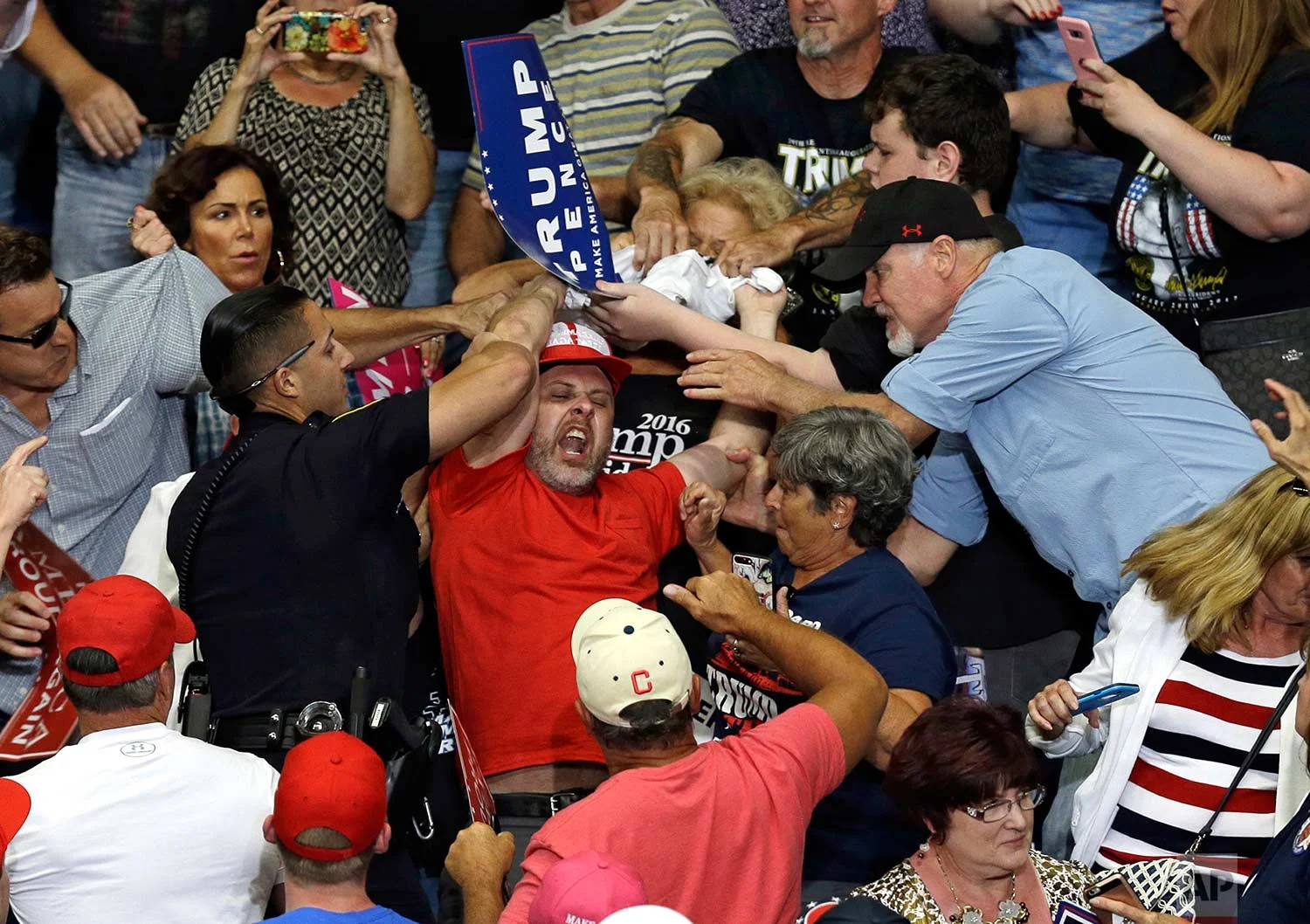 A protester is escorted out of the Covelli Centre during a rally as President Donald Trump speaks, Tuesday, July 25, 2017, in Youngstown, Ohio. (AP Photo/Tony Dejak) 