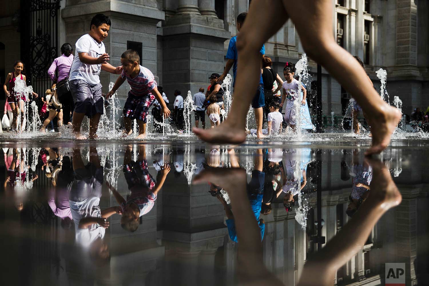  Young people cool off in a fountain at Dilworth Park in Philadelphia, Friday, July 21, 2017. (AP Photo/Matt Rourke) 