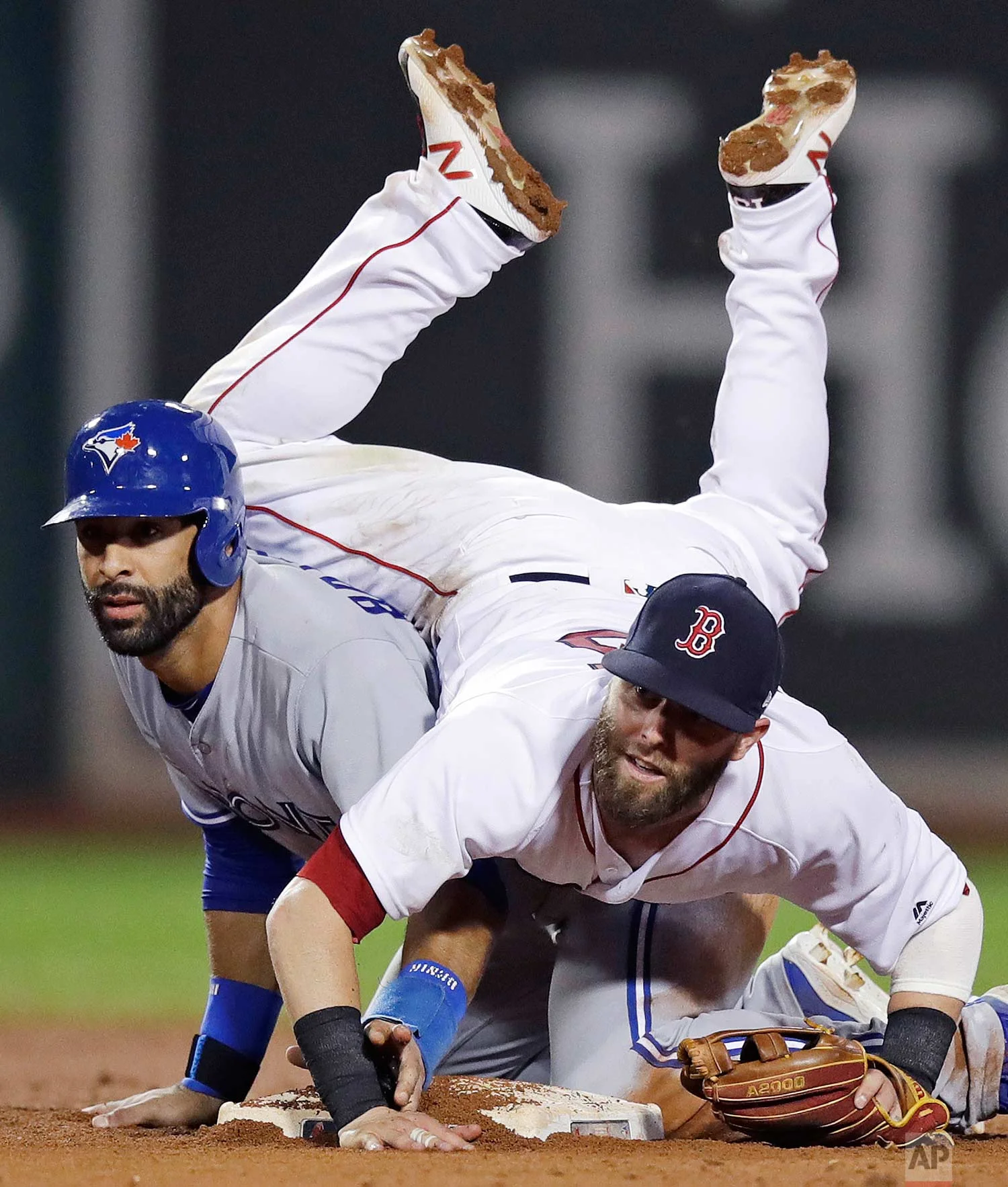  Boston Red Sox second baseman Dustin Pedroia lands on Toronto Blue Jays' Jose Bautista after turning a double play during the 11th inning of a baseball game at Fenway Park in Boston, Tuesday, July 18, 2017. (AP Photo/Charles Krupa) 