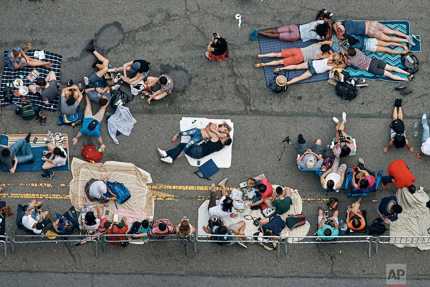  People gather to watch the fireworks display over the East River on the Fourth of July, Tuesday, July 4, 2017, in the Queens borough of New York. (AP Photo/Andres Kudacki) 