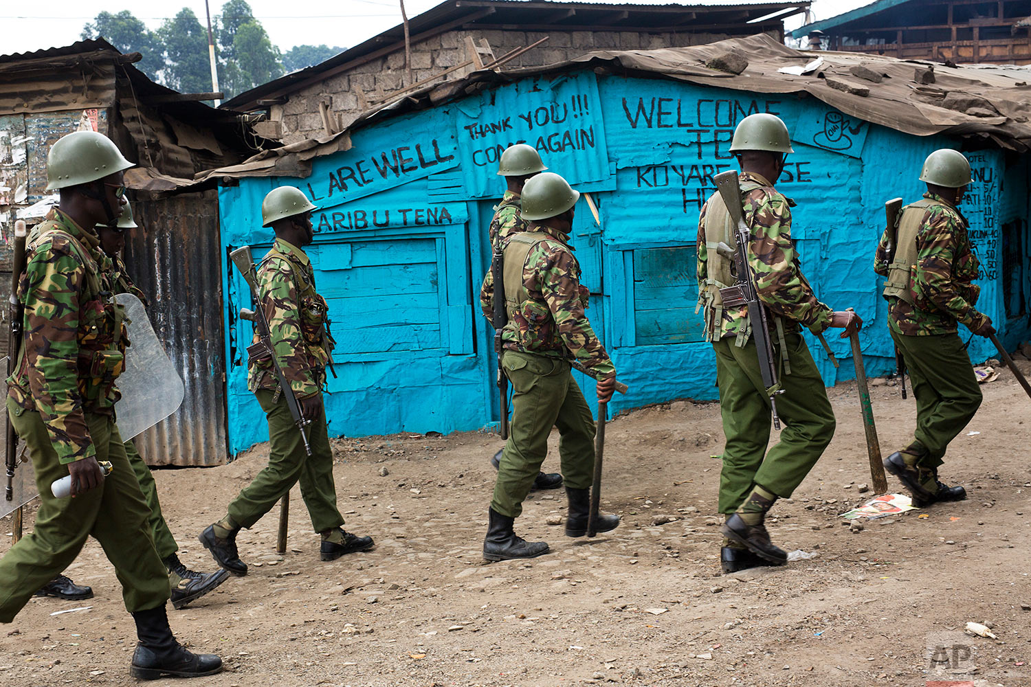  Kenyan security forces chase supporters of Kenyan opposition leader and presidential candidate Raila Odinga who demonstrated in the Mathare area of Nairobi, Wednesday, Aug. 9, 2017. Odinga alleges that hackers manipulated the Tuesday election result