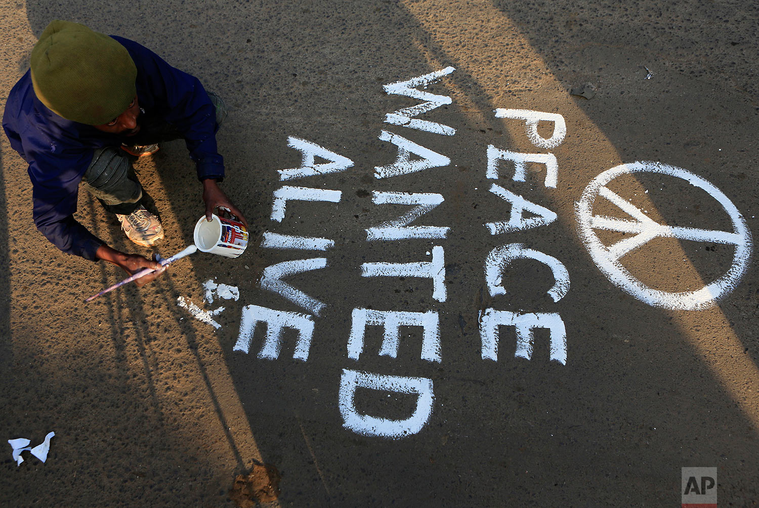  An artist paints a section of the main street into Kibera calling for peace as residents protested in this densely populated suburb in the outskirts of Nairobi, Kenya, Wednesday, Aug. 9, 2017. Kenya's election took an ominous turn on Wednesday as vi