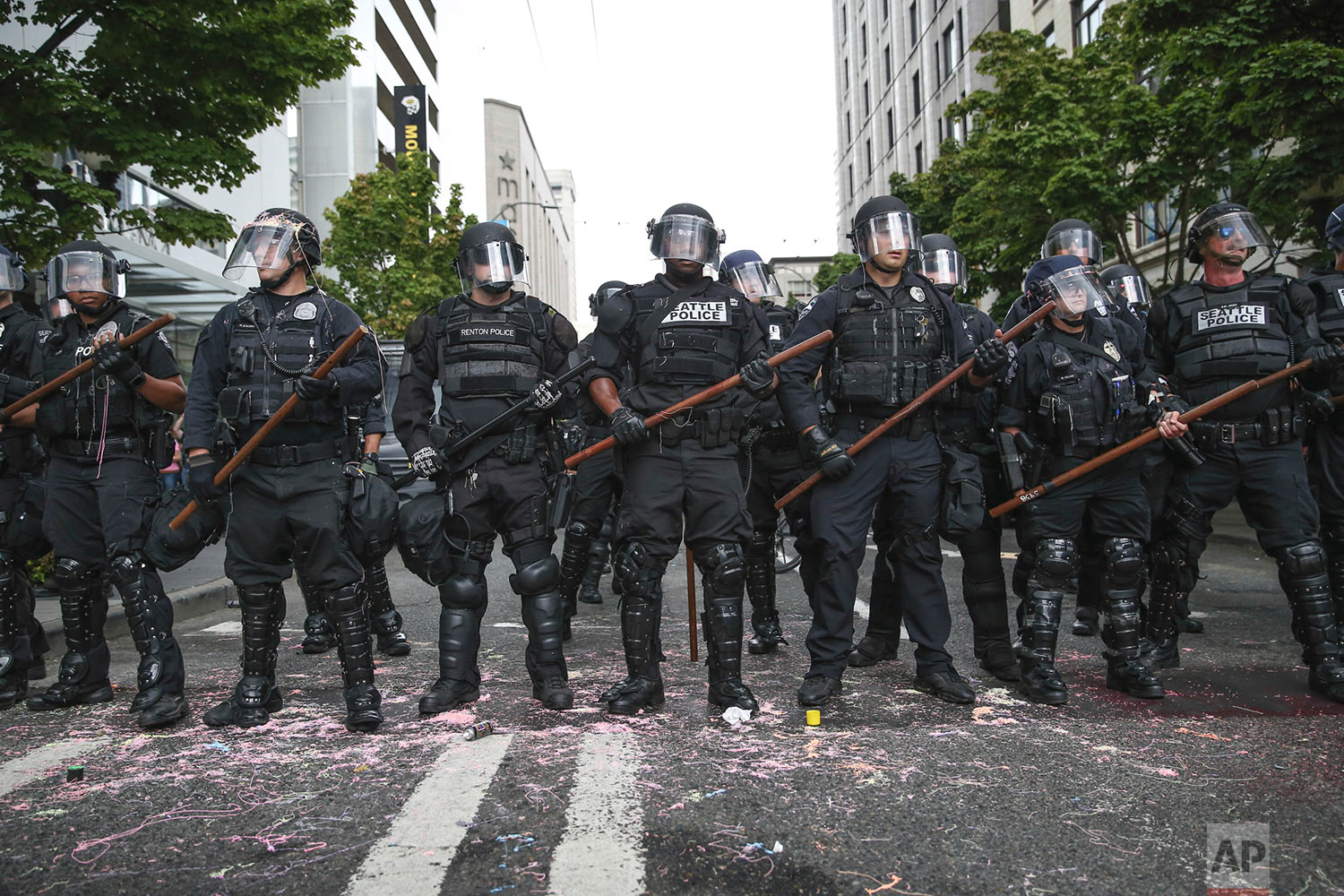  Police stand during a rally Sunday, Aug. 13, 2017, in Seattle. Hundreds of demonstrators and counter-protesters converged in downtown Seattle one day after violent clashes in Charlottesville, Va. (Grant Hindsley/seattlepi.com via AP) 