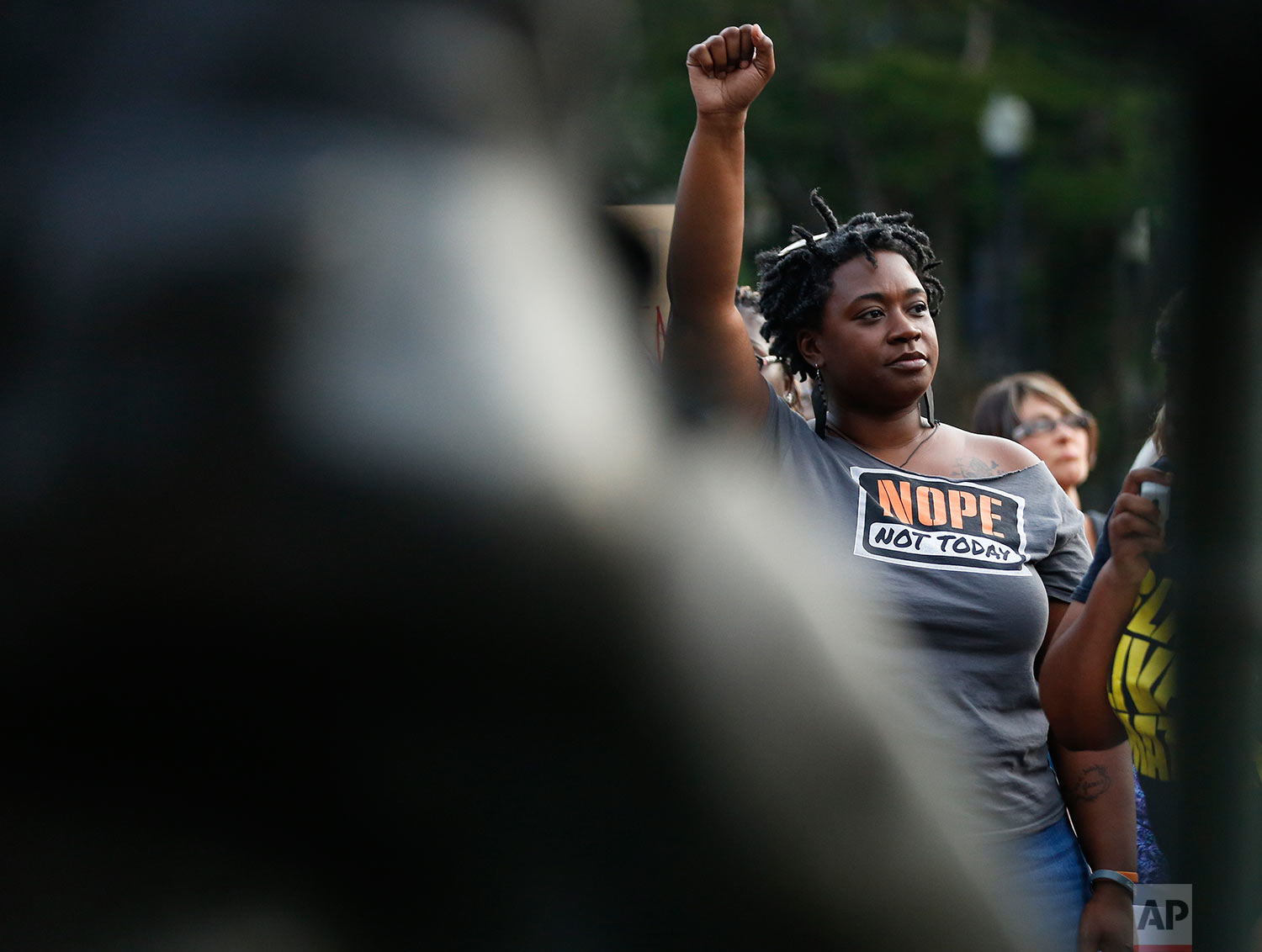  Ericka Robbins, of Birmingham, Ala., holds up her fist during a solidarity rally Sunday, Aug. 13, 2017, in Birmingham for the victims in Charlottesville, Va. (AP Photo/Brynn Anderson) 